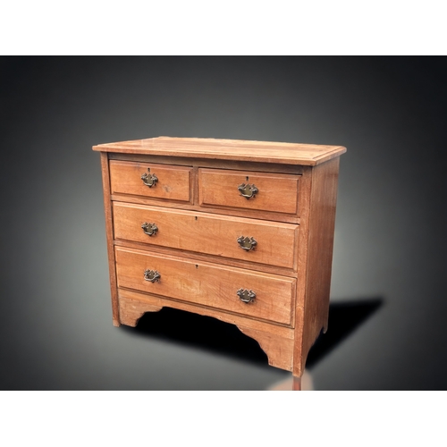 27 - A LATE VICTORIAN WAXED PINE FOUR DRAWER CHEST OF DRAWERS.