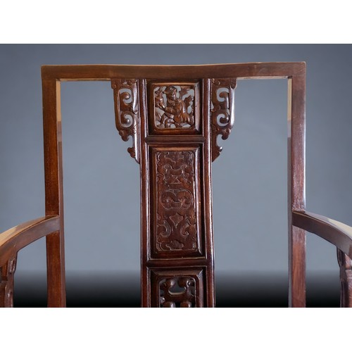 40 - A CHINESE CARVED HARDWOOD ARMCHAIR, 20TH CENTURY. The splat carved with a figure and pierced apron. ... 