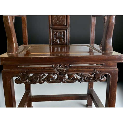 40 - A CHINESE CARVED HARDWOOD ARMCHAIR, 20TH CENTURY. The splat carved with a figure and pierced apron. ... 