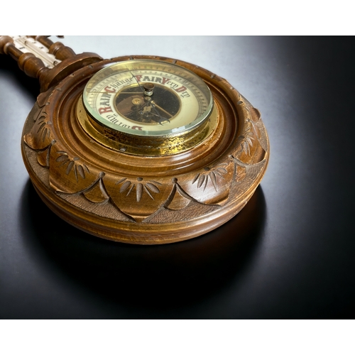 322 - AN EDWARDIAN CARVED WOOD 'BANJO' BAROMETER & THERMOMETER. TOGETHER WITH TWO 'SHIPS WHEEL' BAROMETERS... 