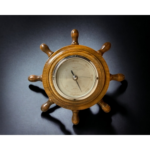 322 - AN EDWARDIAN CARVED WOOD 'BANJO' BAROMETER & THERMOMETER. TOGETHER WITH TWO 'SHIPS WHEEL' BAROMETERS... 