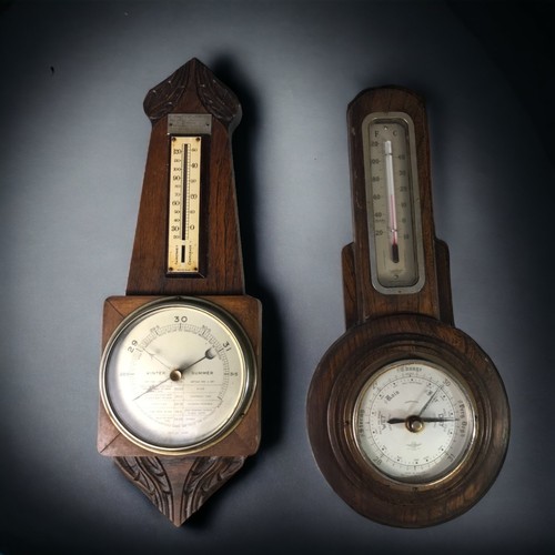 323 - A PAIR OF CARVED OAK BAROMETERS, 20TH CENTURY