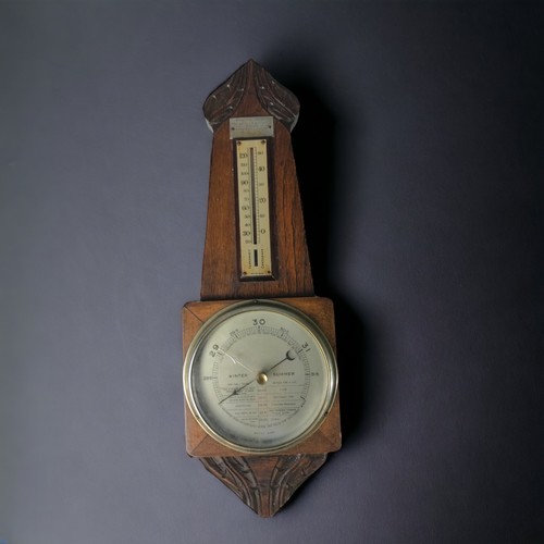 323 - A PAIR OF CARVED OAK BAROMETERS, 20TH CENTURY