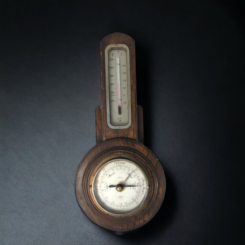 323 - A PAIR OF CARVED OAK BAROMETERS, 20TH CENTURY