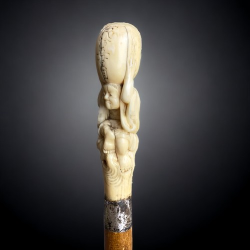 234 - A Japanese Meiji period carved walking stick.
Carved Marine bone figural handle, signed. 
With silve... 