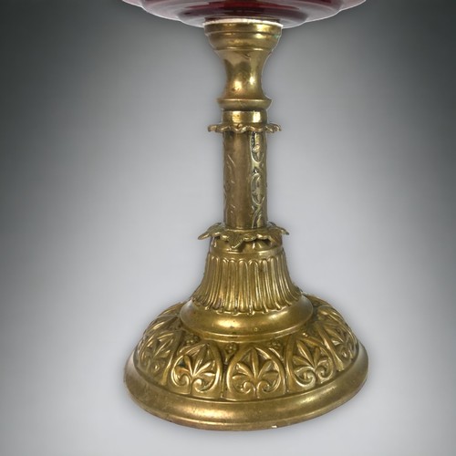 384 - A VICTORIAN RUBY GLASS OIL LAMP. 
CAST BRASS BASE, WITH RUBY WELL AND CRINKLE & ETCHED SHADE. 
52CM ... 