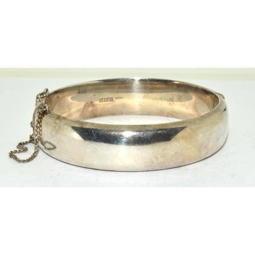 146 - Silver embossed ladies hinged bangle with safety chain 7cm diameter