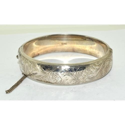 146 - Silver embossed ladies hinged bangle with safety chain 7cm diameter