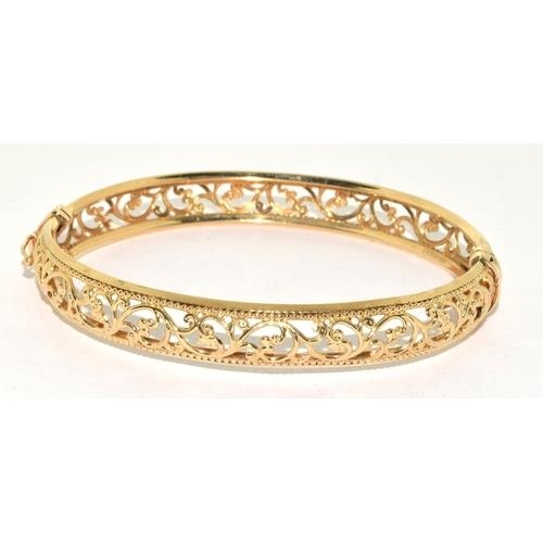 297 - 9ct gold open work bangle with spring closed mechanism