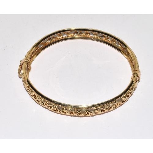 297 - 9ct gold open work bangle with spring closed mechanism