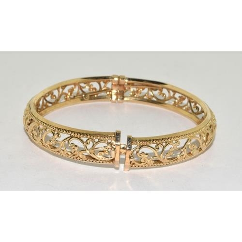 297 - 9ct gold open work bangle with spring closed mechanism