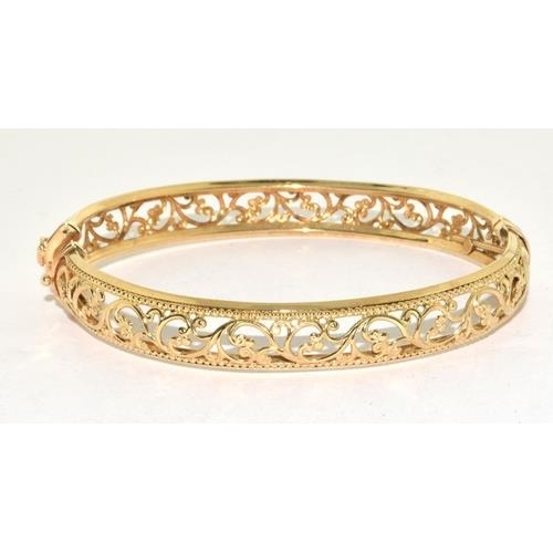 297 - 9ct gold open work bangle with spring closed mechanism