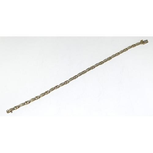 219 - 9ct gold ladies Diamond bracelet set with bagget cut diamonds of approx 2ct tota