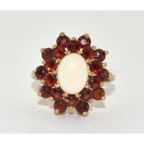 5 - 9ct gold ladies Opal and Garnet cluster ring in the halo pattern size O