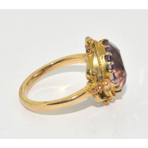 291 - 9ct gold ladies oval Amethyst in an ornate bezel setting solitaire statement ring size M