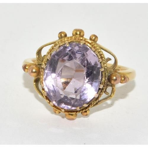 291 - 9ct gold ladies oval Amethyst in an ornate bezel setting solitaire statement ring size M