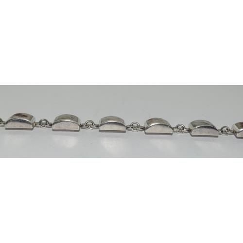 261 - A silver shell panel bracelet.