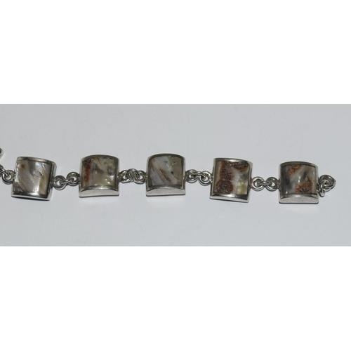 261 - A silver shell panel bracelet.