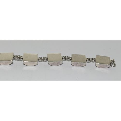 261 - A silver shell panel bracelet.