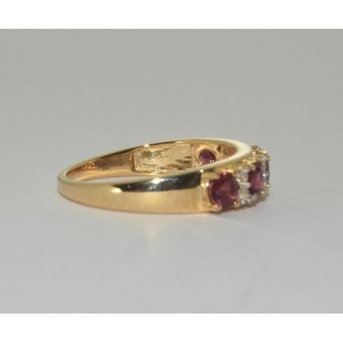 266 - A 9ct gold pink tourmaline 1/2 eternity ring.