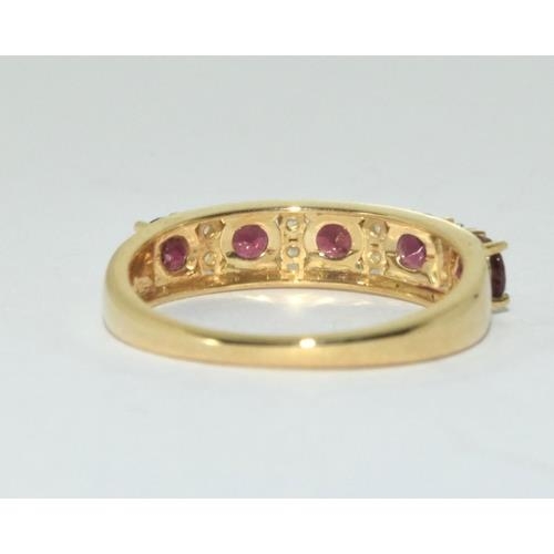 266 - A 9ct gold pink tourmaline 1/2 eternity ring.