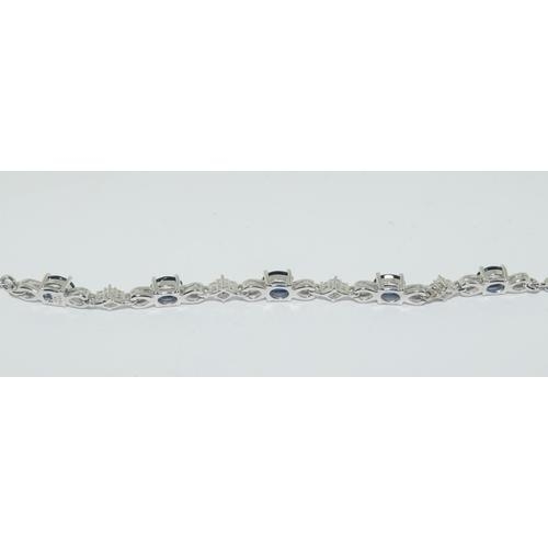 249 - A silver sapphire bracelet.