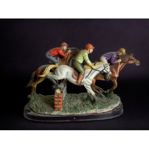 158 - THREE RESIN HORSE RACING JOCKEY FIGURINES. 
LARGEST 15