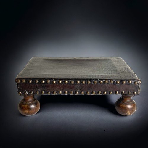 2 - A 19TH CENTURY LEATHER FOOT STOOL , WITH BRASS STUDS AND BALL FEET.