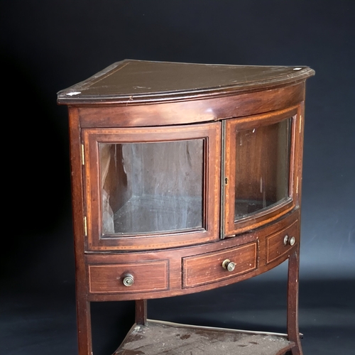 43 - A SHERATON TYPE VICTORIAN CORNER CABINET.
BOW FRONTED, WITH INLAID DESIGN AND ONE CENTRAL DRAWER & T... 