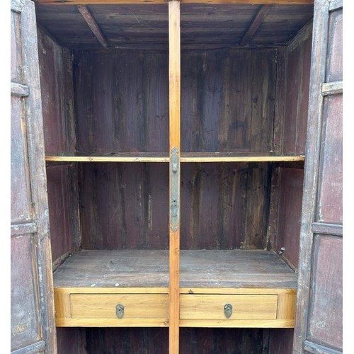 59 - A TALL CHINESE ELM NOODLE CUPBOARD. TAPERED FORM, WITH FITTED INTERIOR. IN THE MING STYLE.