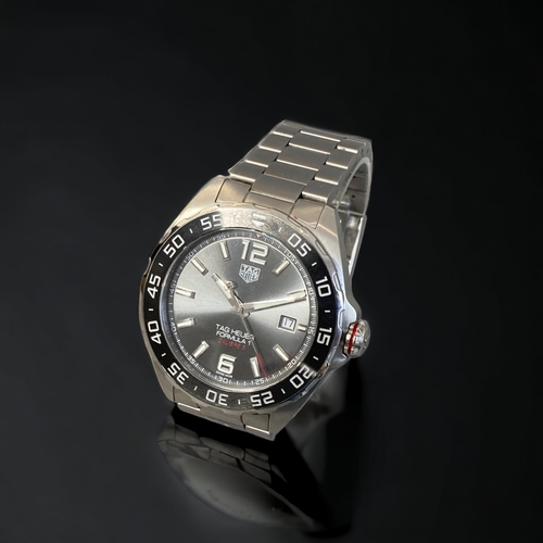 130 - A TAG HEUER FORMULA 1 CALIBRE 5 MENS WRISTWATCH.
BRUSHES STEEL CASE, WITH BLACK CERAMIC TACHYMETER B... 