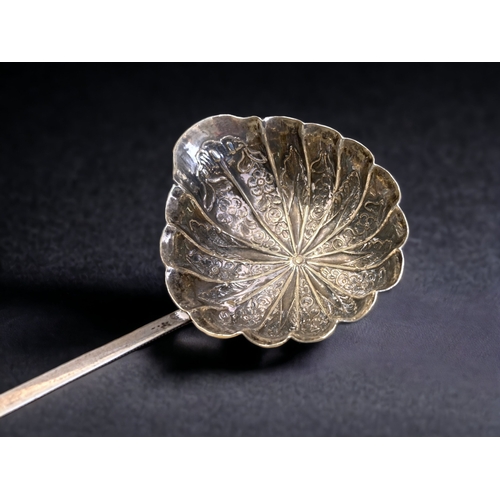 114 - A 19TH CENTURY SILVER TODDY LADLE. WITH BALEEN TWIST HANDLE AND FOLIATE DESIGN TO BOWL.  UNMARKED (T... 