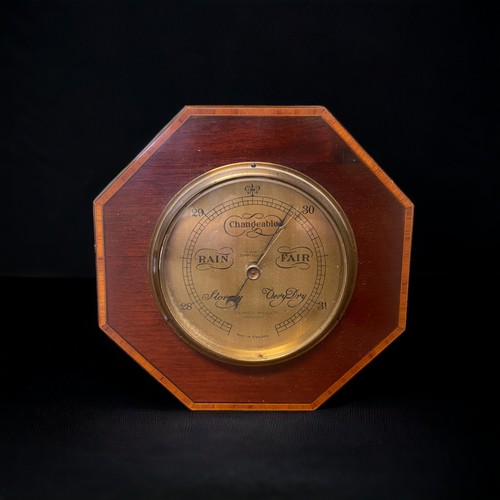 168 - AN EDWARDIAN INLAID BAROMETER .
OCTAGONAL FORM.
RETAILED BY T.T JOHNSON OF SALISBURY.
8.5