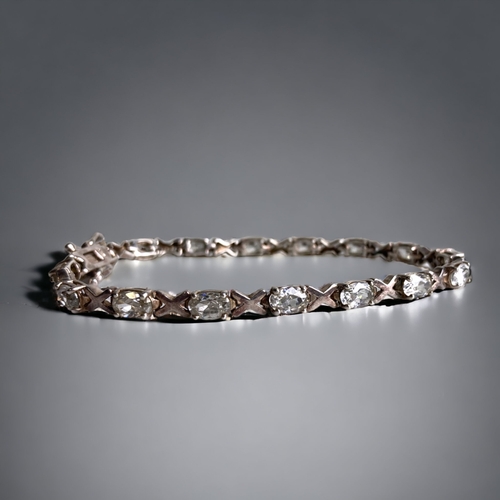 100B - A STERLING SILVER BANGLE SET WITH THREE STONES, TOGETHER WITH A SIMILAR STERLING SILVER BRACELET.