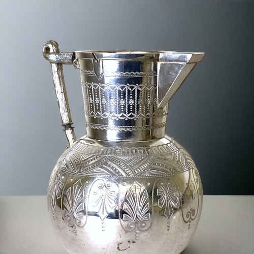 55 - A 19TH CENTURY BRITANNIA METAL EWER. DECORATED IN A ETCHED DR CHRISTOPHER DRESSER STYLE, WITH A NUTR... 