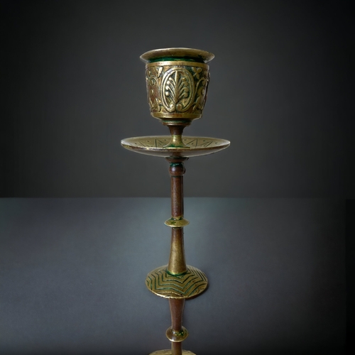 63 - A PAIR OF 19TH CENTURY BRASS / GILT BRONZE CANDLESTICKS. DECORATED WITH A DRESSER TYPE DESIGN. 
22CM... 