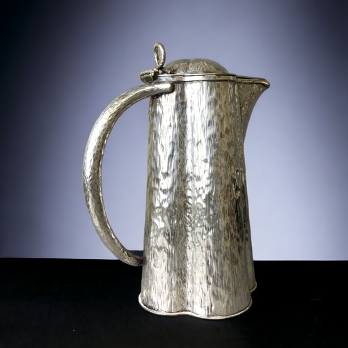 85 - A CHRISTOPHER DRESSER, HUKIN & HEATH SILVER PLATE LIDDED JUG. 
22CM TALL.