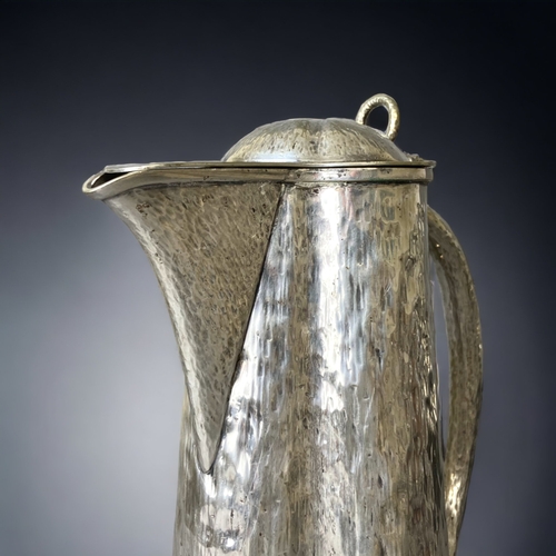 85 - A CHRISTOPHER DRESSER, HUKIN & HEATH SILVER PLATE LIDDED JUG. 
22CM TALL.