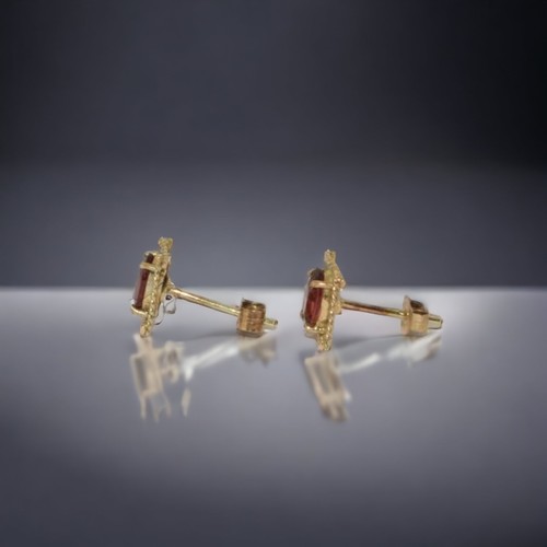 155 - A pair of 9ct Gold & Garnet ear studs.