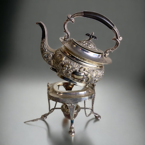 181 - A VICTORIAN SILVER PLATE SPIRIT KETTLE. RELIEF DECORATED STYLISED FOLIATE DESIGN. ON HINGES.