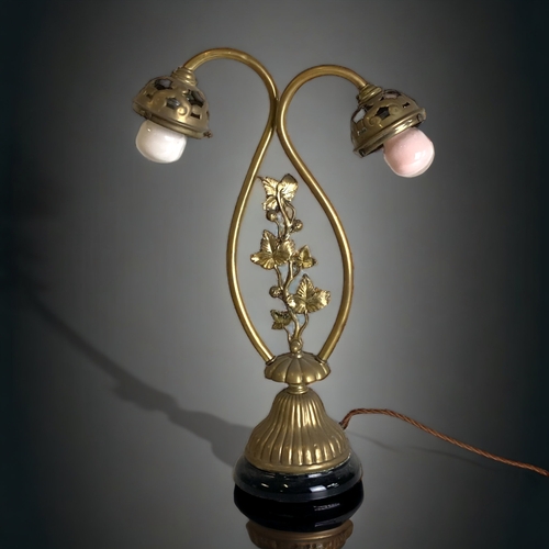 101 - A BRASS ART NOUVEAU TWIN BRANCH LAMP.
ON BLACK GLASS BASE.
 54CM TALL.