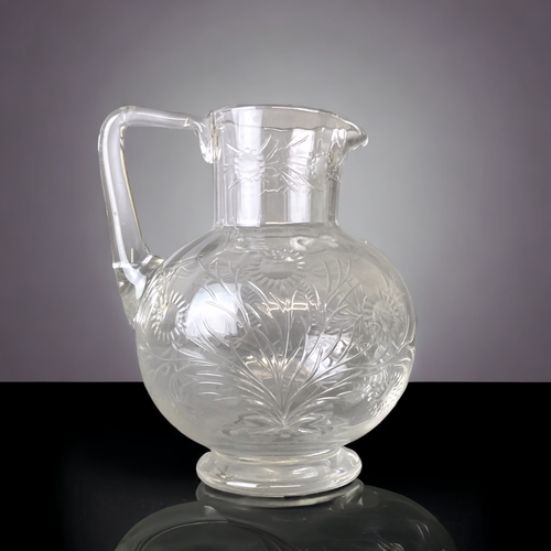 102 - A VICTORIAN CHRISTOPHER DRESSER DESIGN GLASS JUG. ENGRAVED IN STYLISED FOLIATE DESIGNS. 
13CM TALL