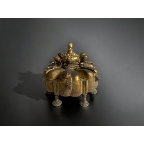 241 - AN ANTIQUE INDIAN GILT BRONZE KUMKUMA SPICE BOX. WITH SIX SPICE COMPARTMENTS IN A LOTUS FLOWER DESIG... 