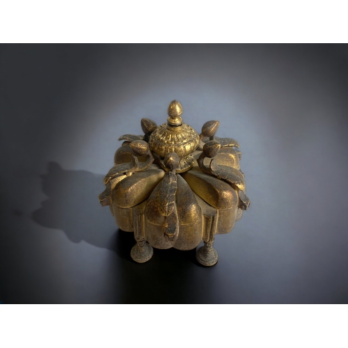 241 - AN ANTIQUE INDIAN GILT BRONZE KUMKUMA SPICE BOX. WITH SIX SPICE COMPARTMENTS IN A LOTUS FLOWER DESIG... 