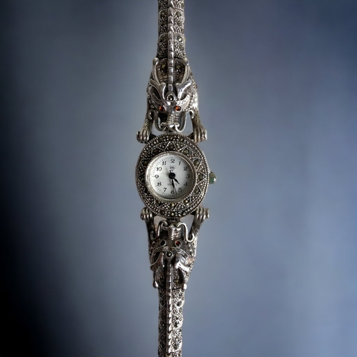 172 - A CHINESE STERLING SILVER TWIN DRAGON STRAP LADIES WATCH. THE STRAP DEPICTING DRAGONS WITH JEWEL SET... 