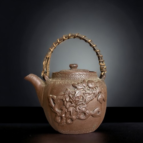 220B - A collection of Chinese teapots. Includes a Yixing relief moulded example, engraved Brass and Cast I... 