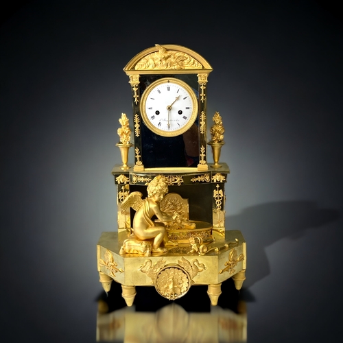 207 - A FRENCH EMPIRE ORMOLU MANTLE CLOCK.
CIRCA 1810.
WHITE ENAMEL DIAL, WITH BLACK ROMAN NUMERALS, SIGNE... 