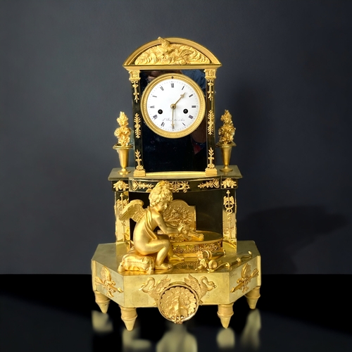 207 - A FRENCH EMPIRE ORMOLU MANTLE CLOCK.
CIRCA 1810.
WHITE ENAMEL DIAL, WITH BLACK ROMAN NUMERALS, SIGNE... 