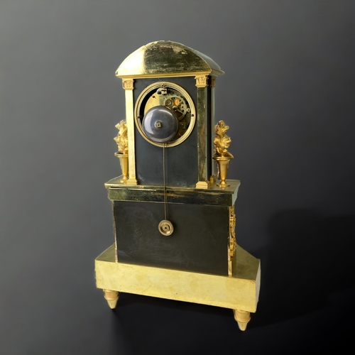 207 - A FRENCH EMPIRE ORMOLU MANTLE CLOCK.
CIRCA 1810.
WHITE ENAMEL DIAL, WITH BLACK ROMAN NUMERALS, SIGNE... 