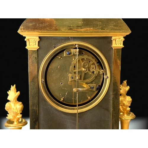 207 - A FRENCH EMPIRE ORMOLU MANTLE CLOCK.
CIRCA 1810.
WHITE ENAMEL DIAL, WITH BLACK ROMAN NUMERALS, SIGNE... 